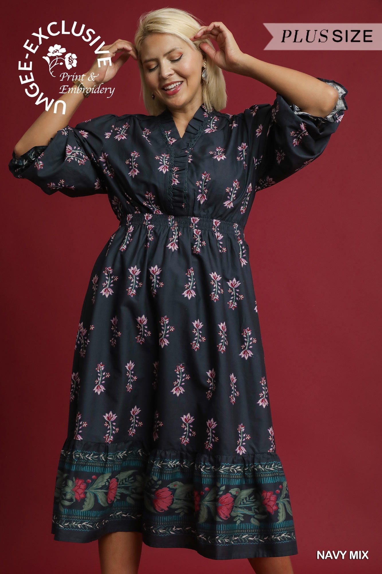 Woman wearing a navy floral dress against a red background with branding text.