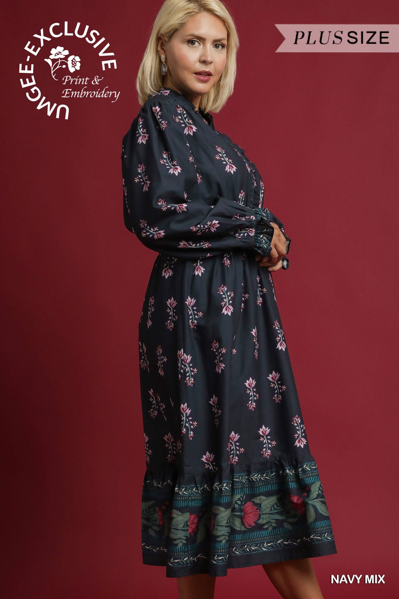 Woman wearing a navy floral dress with a red background, featuring branding text.