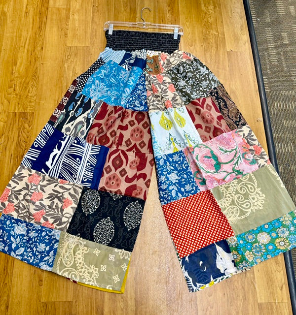 Patchwork pants with various patterns on a wooden floor from Lucky Finds